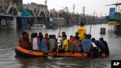 Indian fire officials rescue residents of an area which was flooded following incessant rains, in Ahmadabad, India, July 28, 2017. 