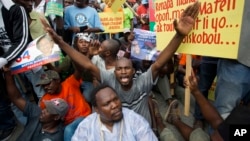 FILE - Demonstrators chant anti-electoral council slogans during a rally protesting against what they claim are fraudulent elections results in Port-au-Prince, Haiti, Dec. 16, 2015.