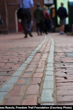 The Freedom Trail is a red brick-lined path leading to 16 historic sites, including the Old South Meeting House.