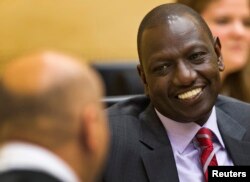 FILE - Kenyan Deputy President William Ruto speaks to his attorney at the International Criminal Court in The Hague, Sept. 10, 2013.