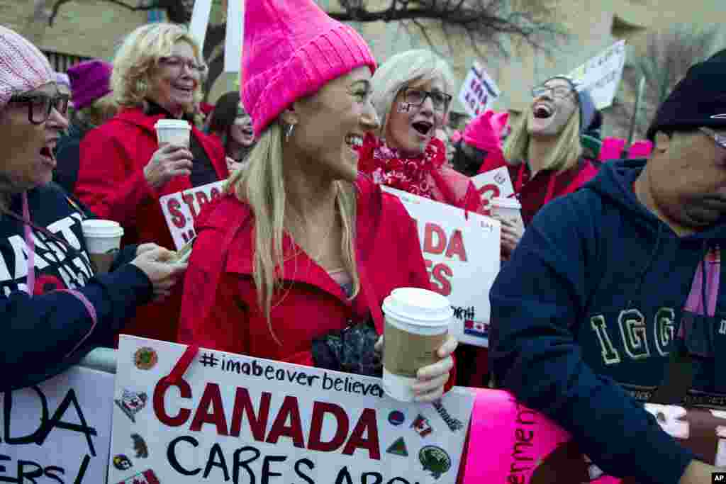 Women with bright pink hats and signs begin to gather early and are set to make their voices heard on the first full day of Donald Trump's presidency, Jan. 21, 2017 in Washington.