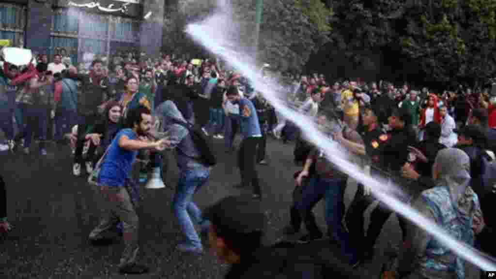 Egyptian police fire water cannons to disperse two protests by dozens of secular anti-government activists in Cairo, November 26, 2013.