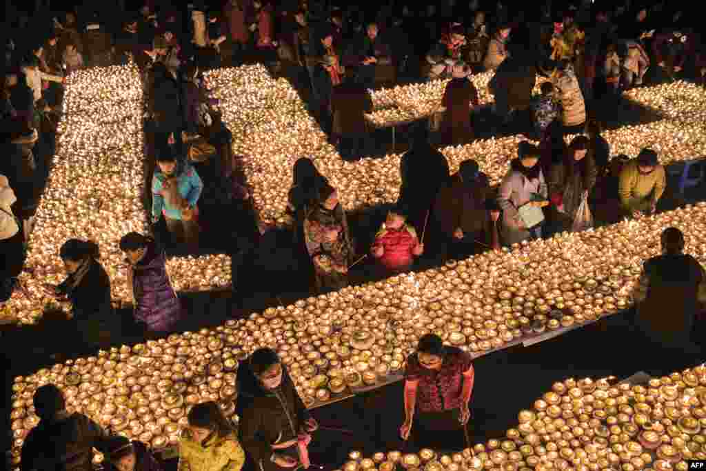 People light lamps during the Butter Lamp Festival, to commemorates Tsong Khapa, a master of Tibetan Buddhism, in Kangding of Ganzi Tibetan Autonomous Prefecture, southwest China's Sichuan Province.