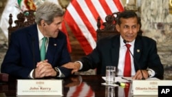 Peru's President Ollanta Humala, right, jokes with U.S. Secretary of State John Kerry — in Lima for a conference on climate change — as they talk to reporters following a private meeting in the Peruvian capital, Dec. 11, 2014.