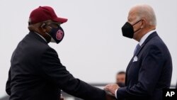 FILE - President Joe Biden is greeted by Rep. Jim Clyburn, D-S.C., as he arrives at Columbia Metropolitan Airport on Air Force One in West Columbia, S.C., en route to deliver the keynote address at South Carolina State University's 2021 Fall Commencement Ceremony in Orangeburg, S.C., Dec. 17, 2021.