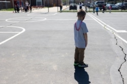 Students play socially distanced during gym class at Kratzer Elementary School in Allentown, Pennsylvania, April 13, 2021.