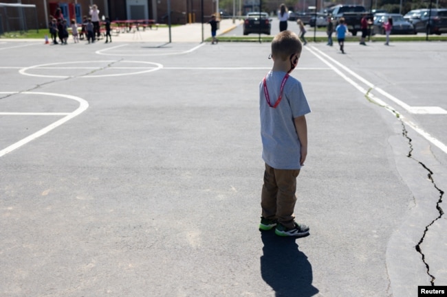 Students play socially distanced during gym class at Kratzer Elementary School in Allentown, Pennsylvania, April 13, 2021.