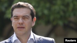 Greek Prime Minister Alexis Tsipras leaves Maximos Mansion for a meeting with party leaders at the Presidential Palace in central Athens, Greece, July 6, 2015. 