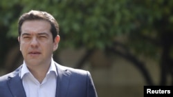 Greek Prime Minister Alexis Tsipras leaves Maximos Mansion for a meeting with party leaders at the Presidential Palace in central Athens, Greece, July 6, 2015. 