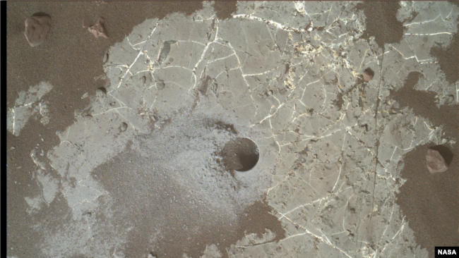 This image shows the Highfield drill hole made by NASA’s Mars Curiosity rover as it was collecting a rock sample on “Vera Rubin Ridge” in Gale Crater. (Photo Credit: NASA/JPL-Caltech/MSSS)