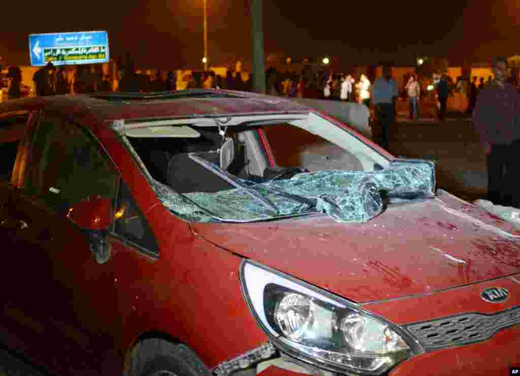 This photo shows a damaged vehicle after a bomb exploded near a national security building in the Shubra el-Kheima neighborhood of Cairo, Aug. 20, 2015.
