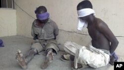 Suspected members of the radical Islamist sect Boko Haram are detained by the military in Bukavu Barracks in Kano state, Nigeria, March 21, 2012. 