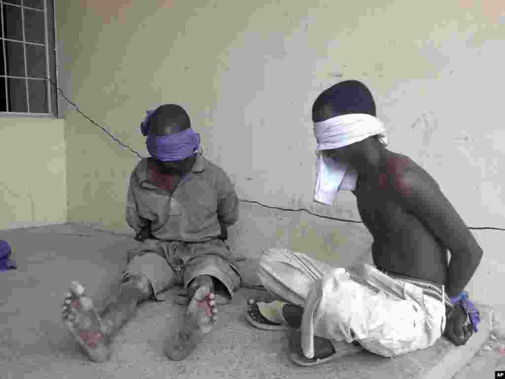 Suspected members of the radical Islamist sect Boko Haram are detained by the military in Bukavu Barracks in Kano state, Nigeria, March 21, 2012. 