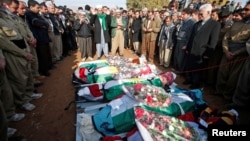 Mourners pray during a funeral of victims who were killed in a bomb attack at the offices of the Democratic Party of Iranian Kurdistan (PDKI) in Koy Sanjak, east of Erbil, Iraq, Dec. 21, 2016.