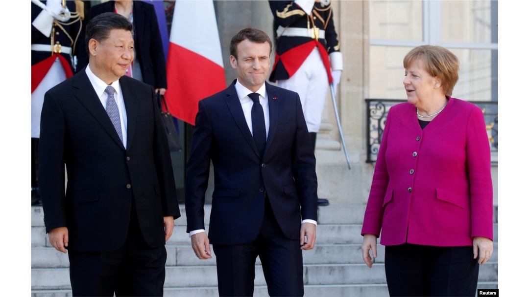 French President Emmanuel Macron, German Chancellor Angela Merkel and Chinese President Xi Jinping leave following a meeting at the Elysee Palace in Paris, France, March 26, 2019.