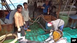 FILE - Fishermen at the Majuro port in the Marshall Islands unload yellowfin tuna on Feb. 1, 2018, for Luen Thai Fishing Venture, one of the companies that was supplying fish that entered the supply chain of Sea To Table. 