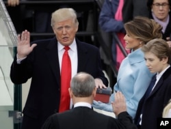 Donald Trump takes the oath of office.