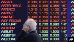 A man talks on his cellular phone at the Australian Stock market in Sydney, August 9, 2011