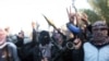 Gunmen gather in a street as they chant slogans against Iraq's Shi'ite-led government and demanding that the Iraqi army don't try to enter the city in Fallujah, Iraq, Jan. 7, 2014. 