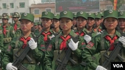 FILE - UWSA female soldiers stand at attention during the 30-year anniversary ceremony in Panghsang, Special Region 2, Shan state, Myanmar, April 17, 2019. (Am Sandford/AsiaReports)