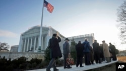 People make their way into the Supreme Court in Washington, March 26, 2013, for the hearing on California’s voter approved ban on same-sex marriage.