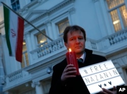 FILE - Richard Ratcliffe husband of imprisoned charity worker Nazanin Zaghari-Ratcliffe, poses for the media during an Amnesty International led vigil outside the Iranian Embassy in London, Jan. 16, 2017.