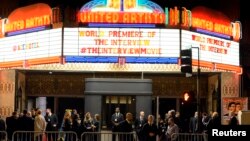 Security guards stand behind bicycle rails at the entrance of United Artists theater during premiere of the film "The Interview" in Los Angeles, California December 11, 2014. REUTERS/Kevork Djansezian (UNITED STATES - Tags: ENTERTAINMENT) - RTR4HPO5