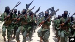 FILE - Al-Shabab fighters are seen marching with their weapons during exercises on the outskirts of Mogadishu, Somalia, Feb. 17, 2011. Somalia-based al-Shabab fighters often strike within Kenya.