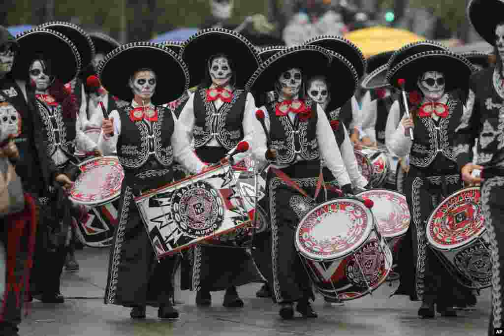 Performers participate in the Day of the Dead parade in Mexico City, Nov. 2, 2019.
