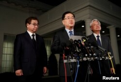 South Korea's National Security Office head Chung Eui-yong, Cho Yoon-je, the South Korean Ambassador to the U.S., and National Intelligence Service chief Suh Hoon, left, make an announcement about North Korea and the Trump administration outside of the West Wing at the White House in Washington, March 8, 2018.