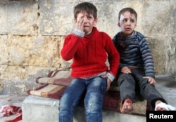 Injured boys react at a field hospital after airstrikes on the rebel held areas of Aleppo, Syria, Nov. 18, 2016.