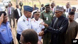 In this photo released by the Nigeria State House, Nigeria President Muhammadu Buhari, second right, is welcomed by Nigeria Service Chiefs, on arrival from his medical leave in London, in Abuja, Nigeria, March 10, 2017. 