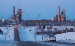 FILE - A car drives near facilities of the Amur gas processing plant, part of Gazprom's "Power of Siberia" project, outside the far eastern town of Svobodny, in Russia's Amur region, Nov. 29, 2019.