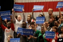 Supporters cheer as Democratic presidential candidate, Sen. Bernie Sanders, I-Vt, speaks at a campaign rally at the Akron Civic Theatre, March 14, 2016, in Akron, Ohio.