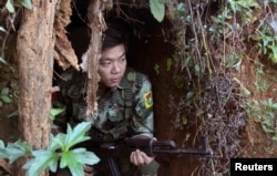 FILE - A Kachin Independence Army (KIA) soldier sits inside the bomb shelter along the bunker at the front line of Alen Bum near Laiza, the headquarters of KIA in Kachin State, Myanmar, Nov. 30, 2016.