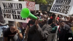 Kenyans demonstrate against their Members of Parliament who last week quietly awarded themselves a $110,000 bonus for five years of service in parliament, in downtown Nairobi, Kenya, October 9, 2012.