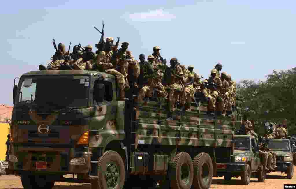 The Sudan People's Liberation Army (SPLA) soldiers ride in a truck in Juba, South Sudan, Dec. 21, 2013. 