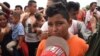 A Honduran migrant boy taking part in a caravan heading to the US, cries as he waits on the Guatemala-Mexico border bridge, in Ciudad Tecun Uman, Guatemala, on Oct. 20, 2018.