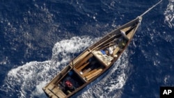 A boat is towed by Japanese coast guard patrol vessel (not pictured) after it was found carrying nine people off the coast of Noto Peninsula, in northwestern Japan, September 13, 2011.