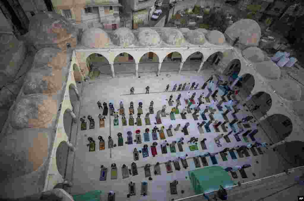 Muslims wearing face masks attend the Eid al-Fitr prayers outside a mosque in Gaza City, May 24, 2020.