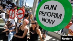 Protesters hold signs as they call for a reform of gun laws three days after the shooting at Marjory Stoneman Douglas High School, at a rally in Fort Lauderdale, Florida, Feb. 17, 2018. 