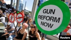 Protesters hold signs as they call for a reform of gun laws three days after the shooting at Marjory Stoneman Douglas High School, at a rally in Fort Lauderdale, Florida, Feb. 17, 2018. 