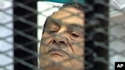 Former Egyptian President Hosni Mubarak is seen in the courtroom for his trial at the Police Academy in Cairo, August 3, 2011.