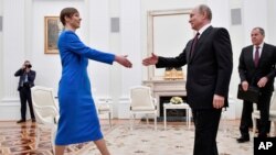 Russian President Vladimir Putin, right, greets Estonia's President Kersti Kaljulaid at the Kremlin in Moscow, Russia, April 18, 2019.
