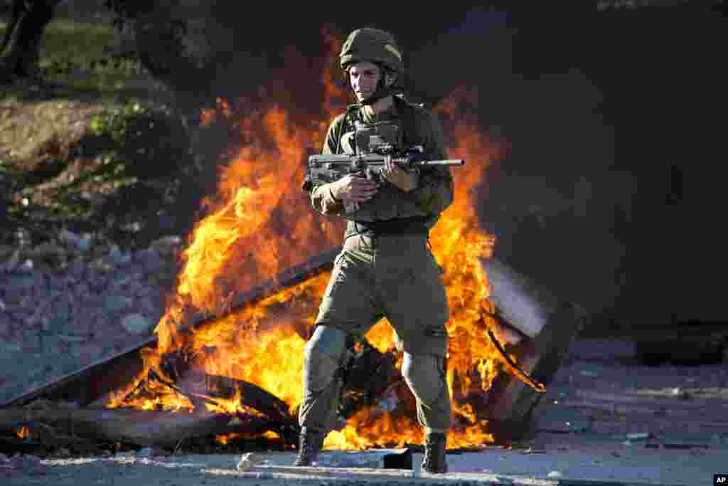 An Israeli soldier stands during clashes with Palestinians following a protest against U.S. President Donald Trump's decision to recognize Jerusalem as the capital of Israel in the West Bank City of Nablus.