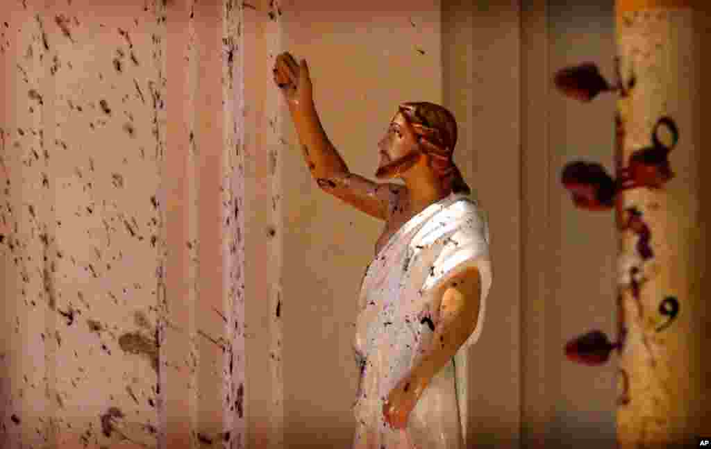 Blood stains are seen on the wall and on a Jesus Christ statue at the St. Sebastian&#39;s Church after blast in Negombo, north of Colombo, Sri Lanka. More than 200 people were killed and hundreds more injured in eight blasts that rocked churches and hotels in and just outside the capital on Easter Sunday.