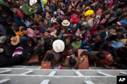 FILE - Villagers place the remains of their recently identified relatives killed during the civil war, in niche graves at the cemetery of Santa Avelina, Guatemala, Nov. 30, 2017.