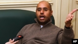 Saif al-Islam Gadhafi, son and heir apparent of Libyan leader Moammar Gadhafi, speaks to a reporter in Tripoli on February 26, 2011