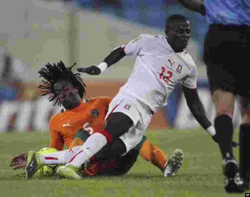 Jean-Jacques Gosso Gosso (L) of Ivory Coast fights for the ball with Thierry Tazemeta of Equatorial Guinea during their quarter-final match at the African Nations Cup soccer tournament in Malabo February 4, 2012.