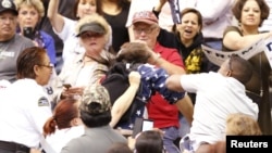 A member of the audience (R) throws a punch at a protester as Republican Presidential candidate Donald Trump speaks during a campaign event in Tucson, Arizona March 19, 2016. 